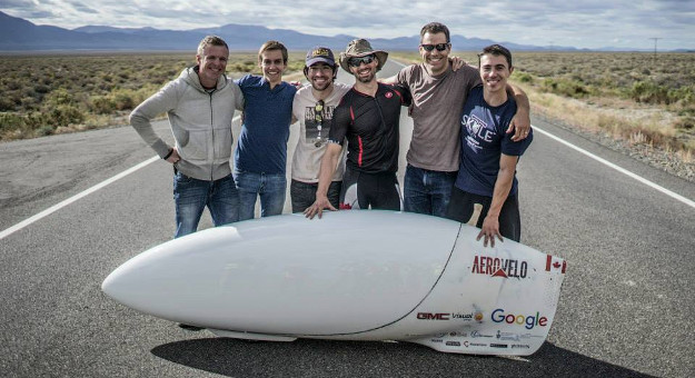 The world’s fastest human, Dr. Todd Reichert (center), with AeroVelo co-founder, Cameron Robertson (second from right), and the rest of the team posing with their world record setting speedbike Eta at the 2015 World Human Powered Speed Challenge in Battle Mountain, Nevada.